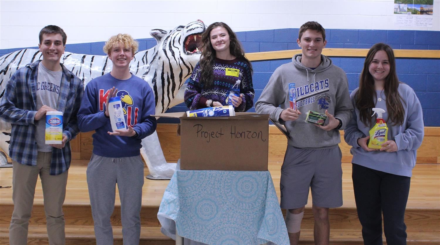   Students present items to representative from Project Horizon